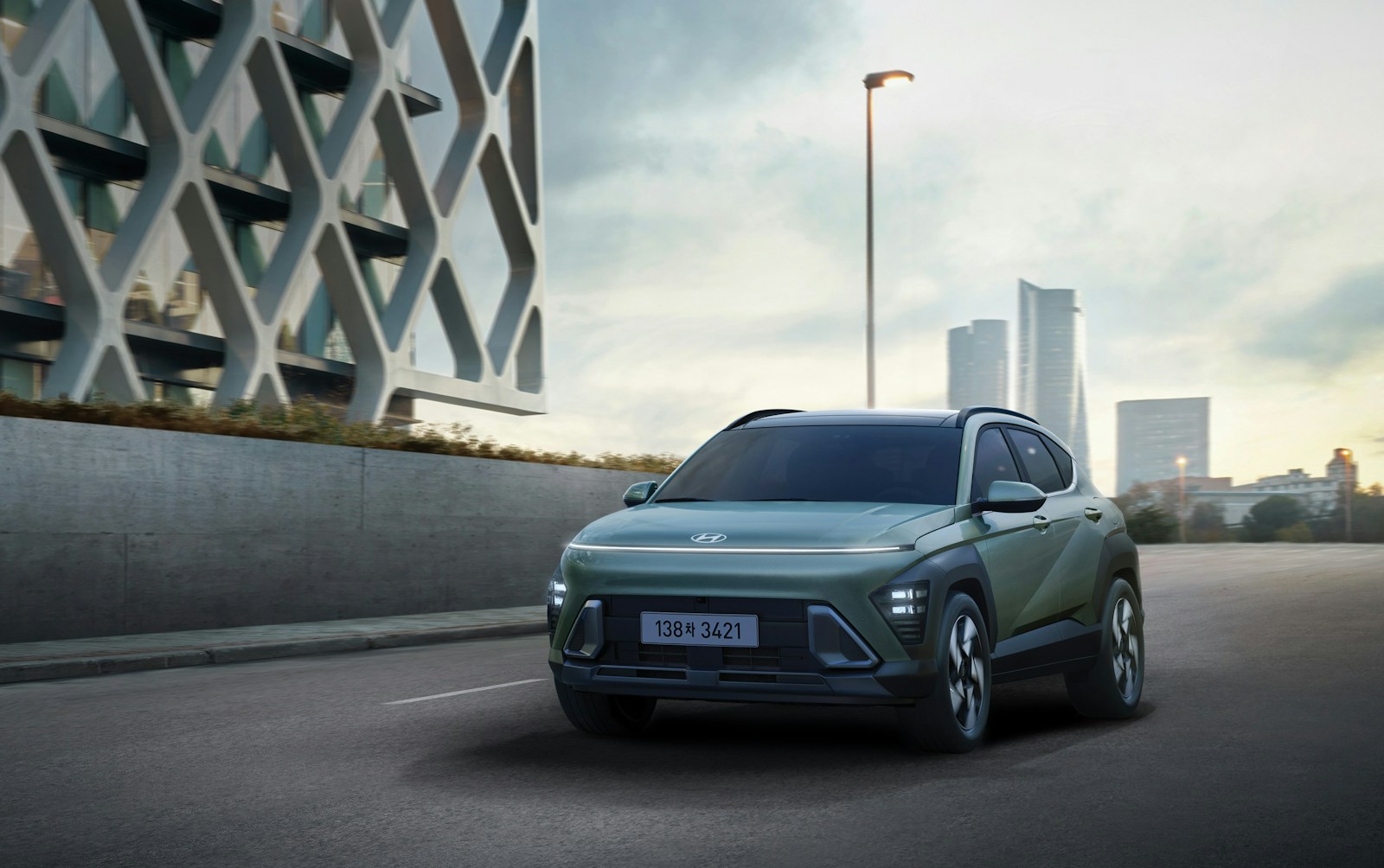 a green suv driving down a city street