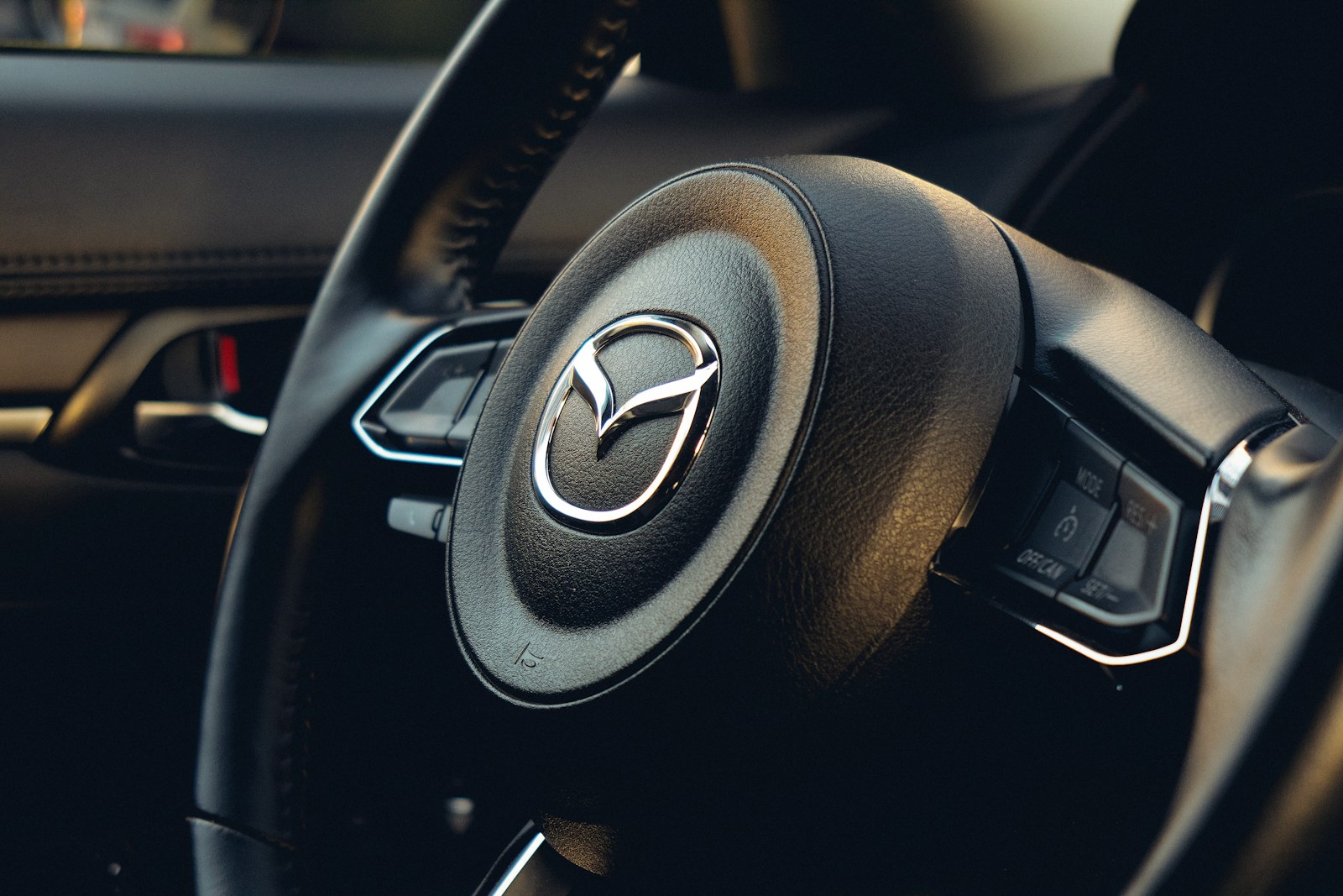 A steering wheel and dashboard of a car