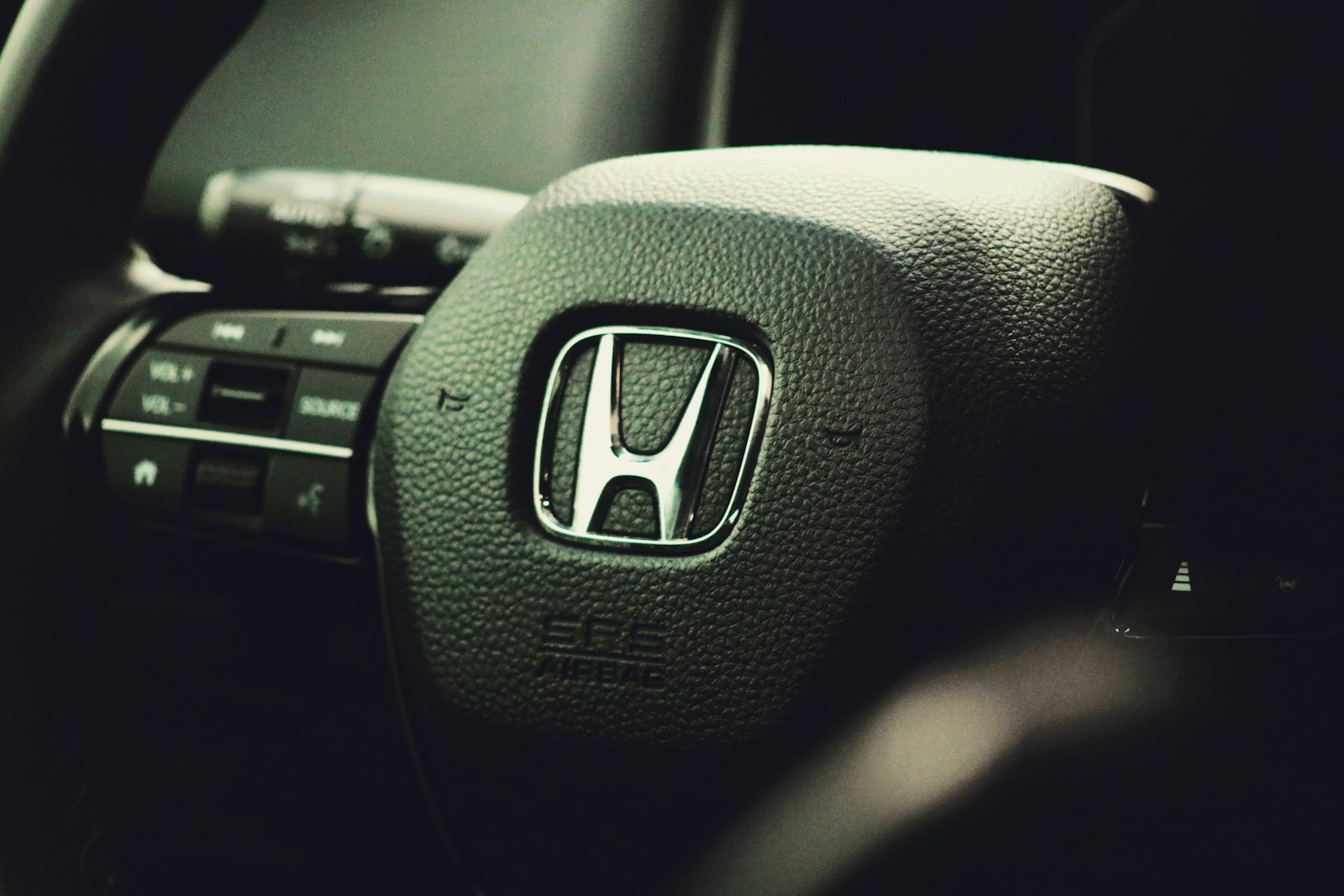 a close up of the steering wheel of a car