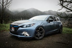 a blue car parked on the side of a road
