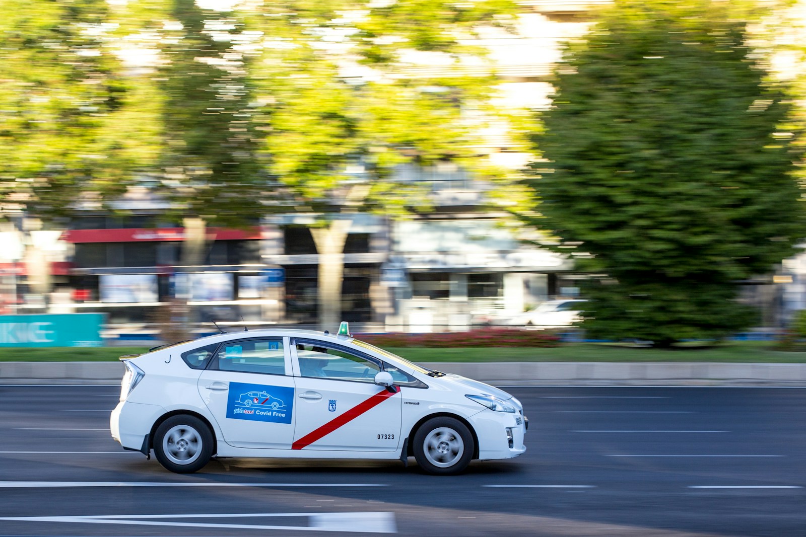 white sedan on road during daytime
