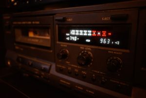 A close up of a radio with a clock on it
