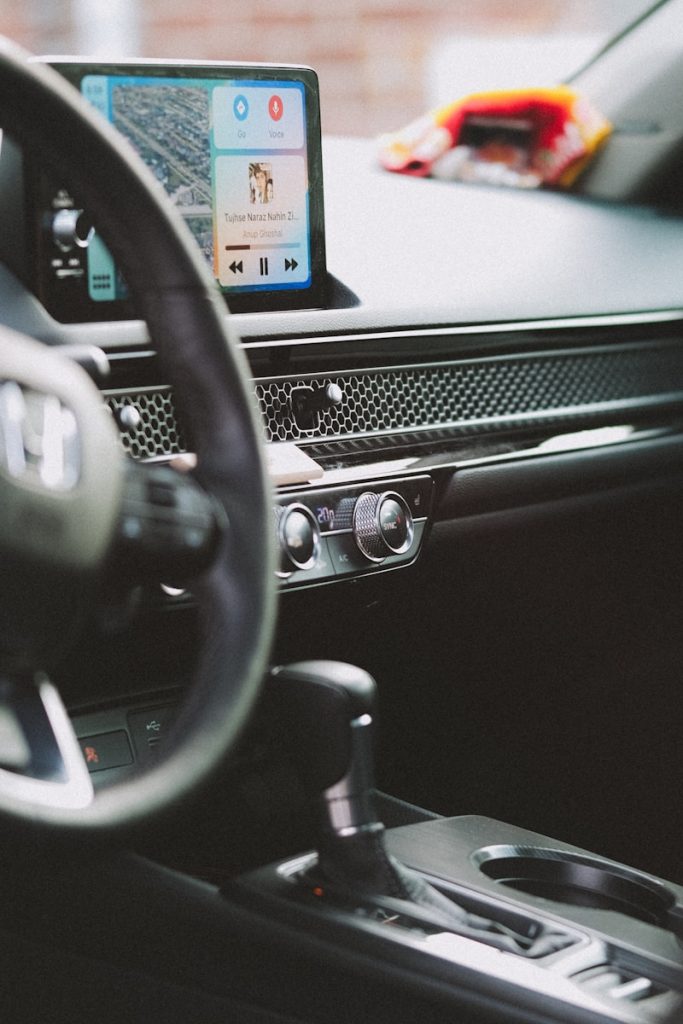 a car dashboard with a cell phone in the center