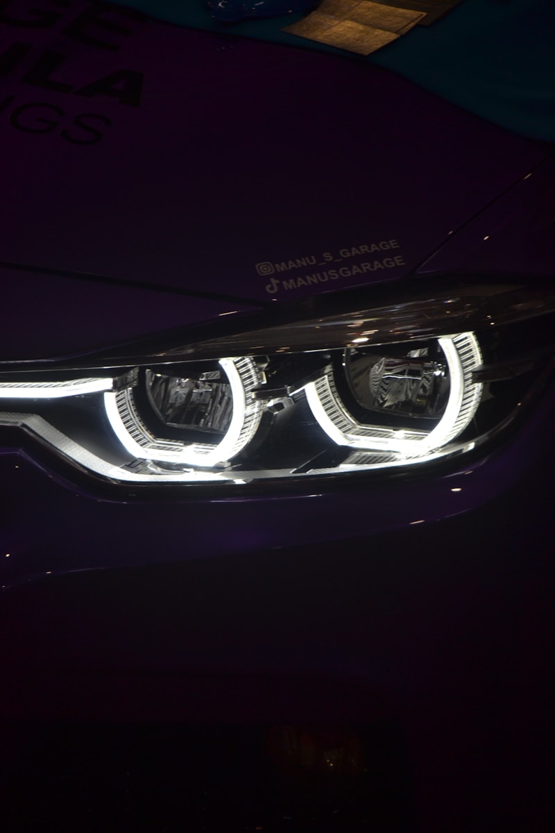 A close up of a car's headlight in the dark