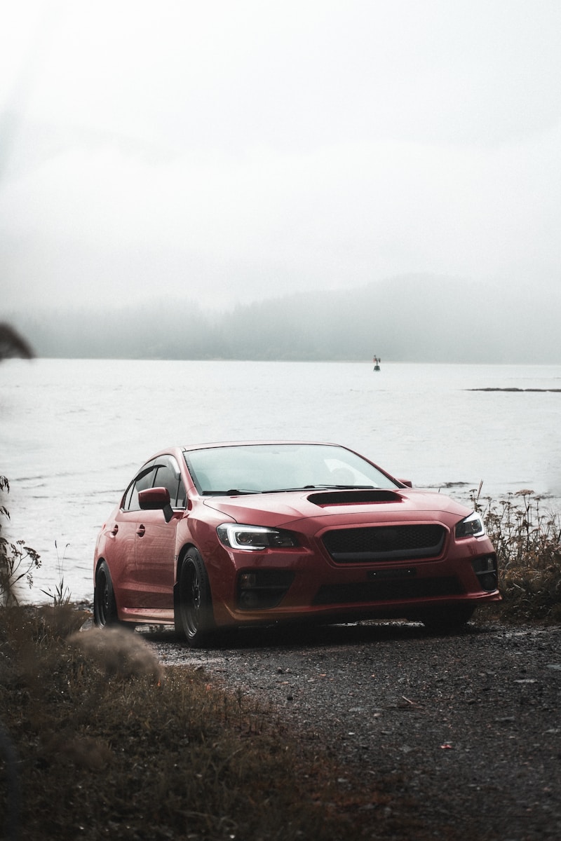 red bmw m 3 coupe parked near body of water during daytime